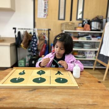Elementary Child working on puzzles at Lifetime Montessori School in San Diego, Highly rated for Best Montessori School in San Diego