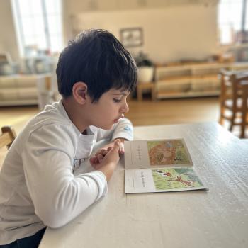 Elementary Child reading at Lifetime Montessori School in San Diego, Highly rated for Best Montessori School in San Diego